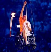 'Hou Bin climbing up a rope in a wheelchair.' logo