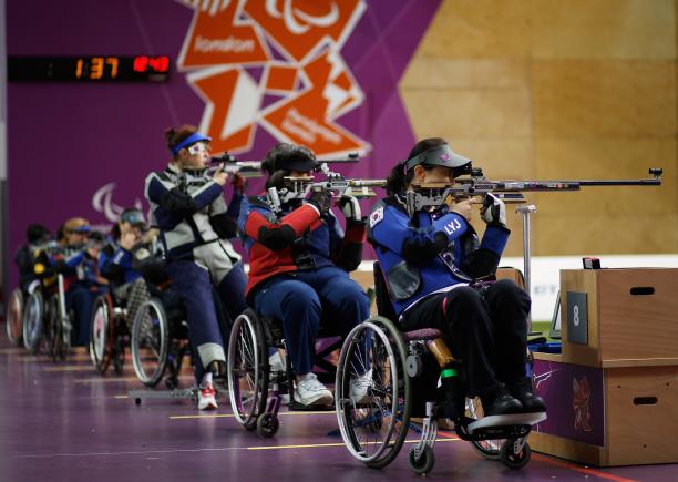 Women shoot under the backdrop of the London 2012 Paralympic games logo during the Women's R8-50m Rifle 3 Positions-SH1 final