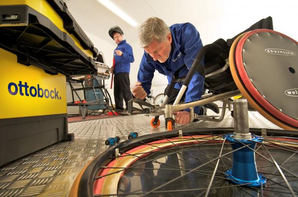 Ottobock Technical Service Team in Action A picture of man fixing up a wheelchair