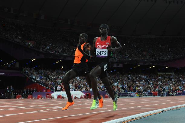 A picture of a blind man running with a guide