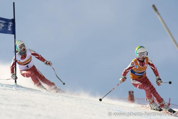 A picture of a woman skiing with her guide