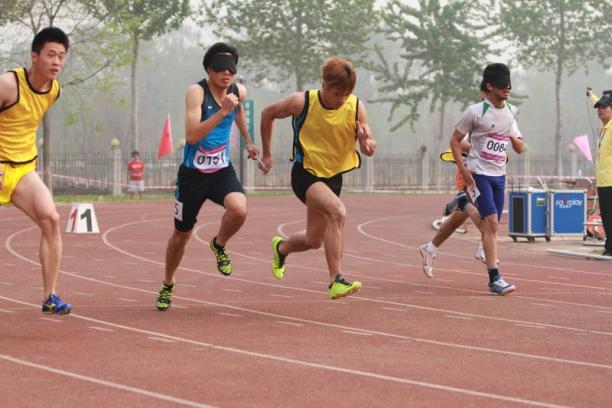 Athletes with a visual impairment compete in the 100m at the 2014 IPC Athletics Grand Prix in Beijing.