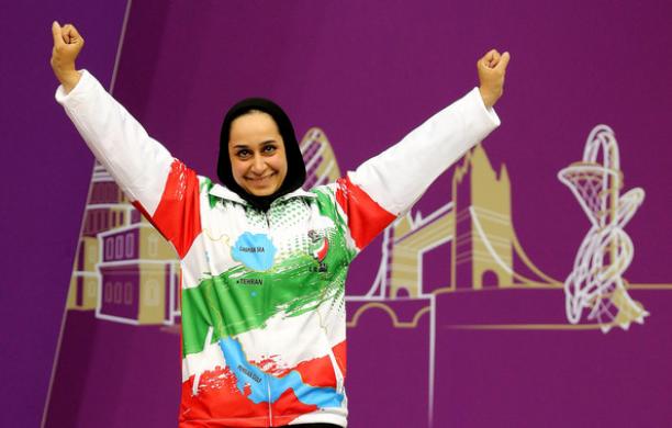 Sareh Javanmardidodmani A woman raises her arms in celebration.