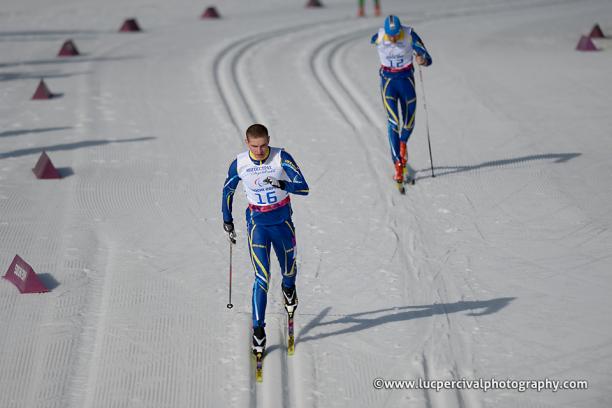 Ukrainian Ihor Reptyukh skis at Sochi 2014 followed closely by a competitor