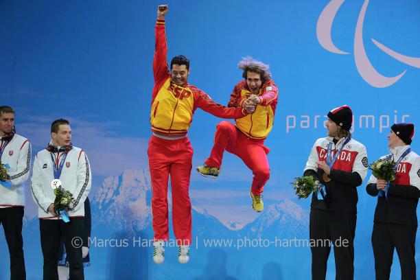 Two men jumping on the podium