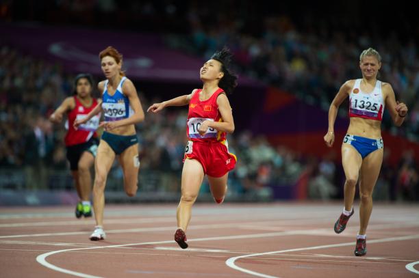 Junfei CHEN - Athletics - London 2012 Paralympic Games Four runners on a track in a stadium