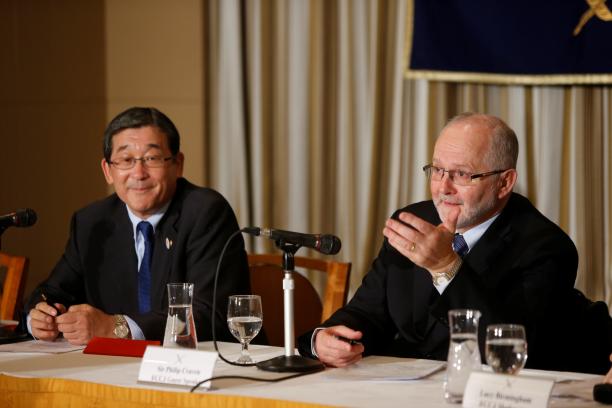 Sir Philip Craven and Yasuhi Yamawaki Two men sitting on a podium behind a table with microphones in front of them