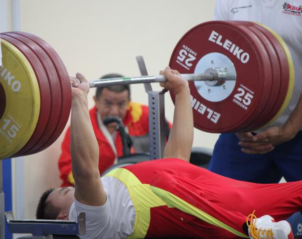 Powerlifter on a bench lifting a bar