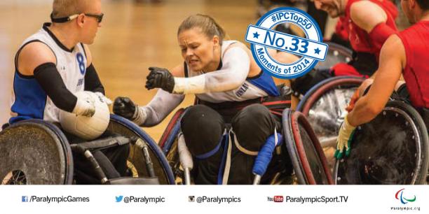 Picture of a female wheelchair rugby player fighting for the ball.