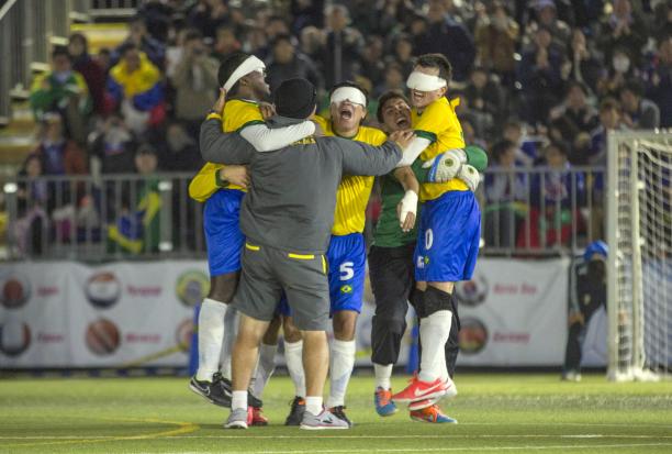 Blindefolded football team celebrating