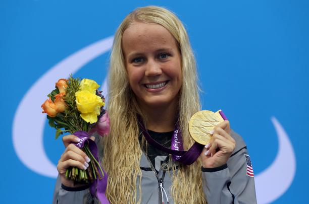 Mallory Weggemann A picture foa a blonde woman showing her gold medal hanging around her neck
