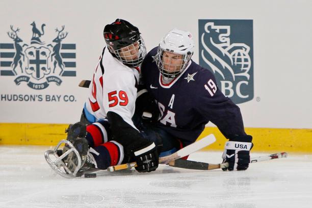 Noritaka Ito and Taylor Chace battling for the puck.