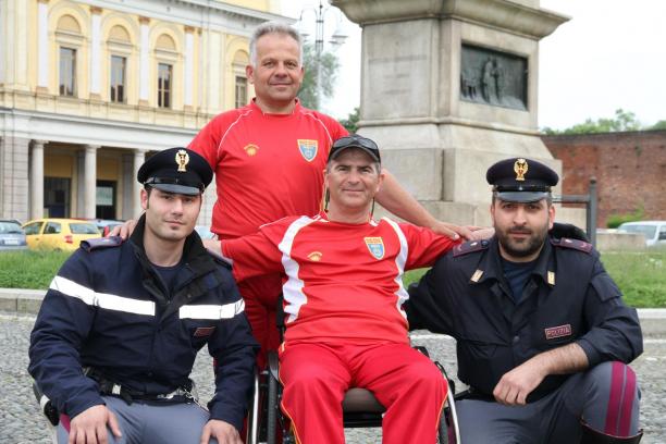 Mile Stojkoski A picture of a man in a wheelchair posing between 2 policemen