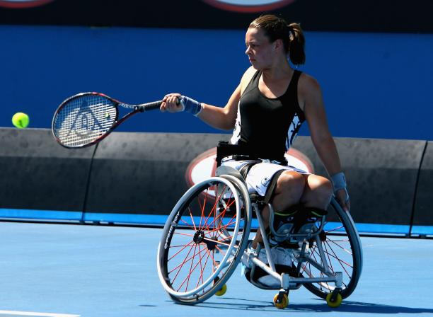 A picture of a girl in a wheelchair playing tennis