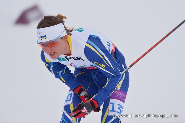 Female skier looks exhausted on the snow.