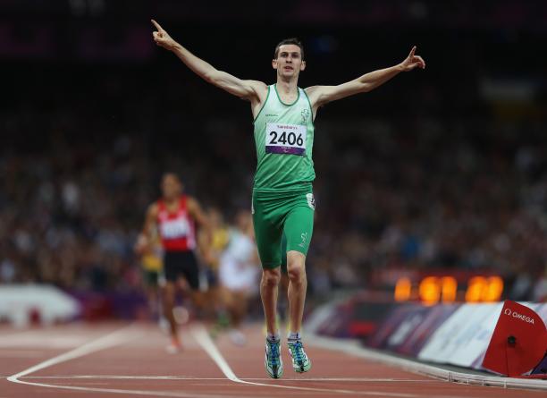 A picture of a man celebrates after crossing a finish line