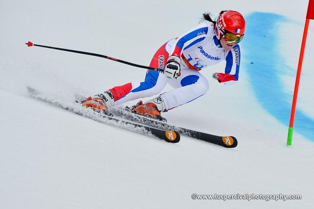 France's standing skier Marie Bochet skiing around a gate.