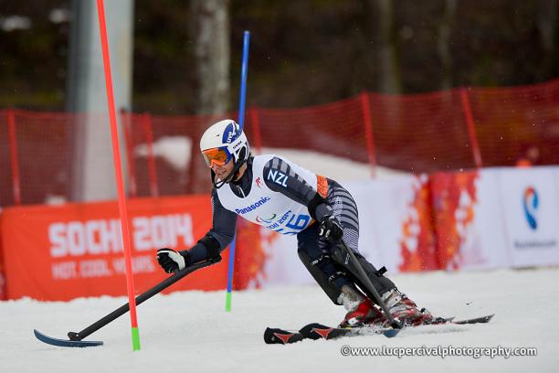 Adam Hall - Sochi 2014 Winter Paralympic Games Skiing man curving around some slalom poles