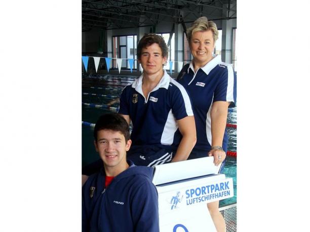 German swimmers Julian Erxleben and Klaus Steinhauer Two young boys and an adult woman pose in front of a swimming pool