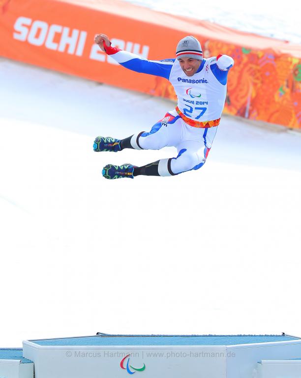 Man jumping in the air on a podium