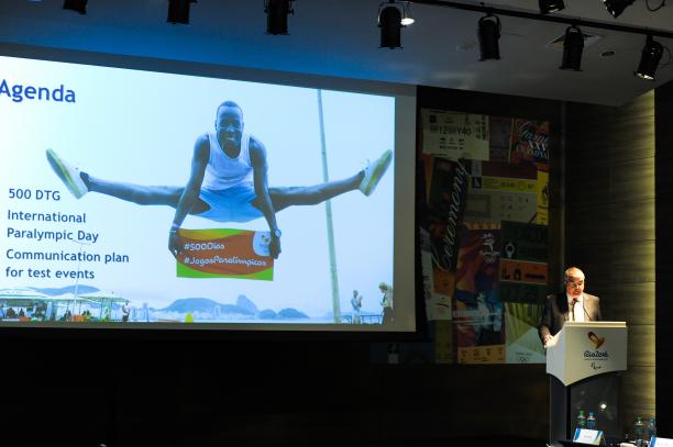 Man on podium, speaking to an audience