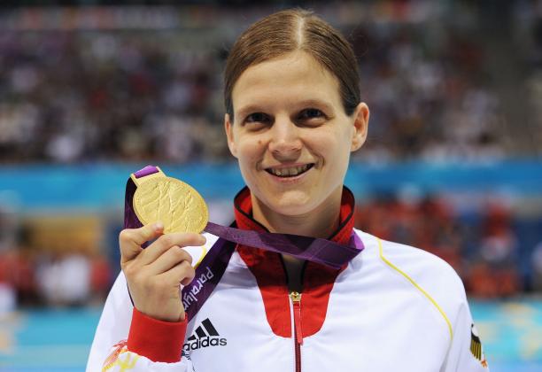 Portrait shot of woman showing a medal and smiling