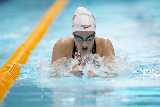 Woman in the pool swimming breaststroke