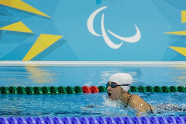 Action shot of Ilena Rodriguez swimming. Her head is just above water