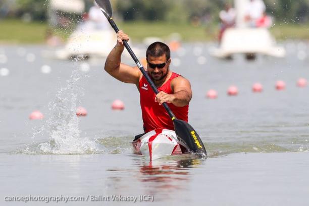 A man paddles in a canoe.