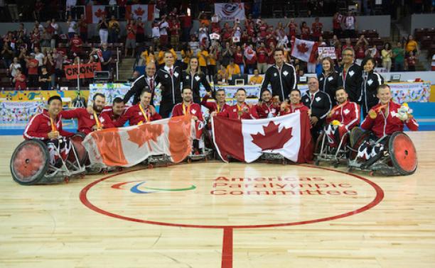 Canada's wheelchair rugby team at Toronto 2015 Team photo of a celebrating group of men sitting in wheelchairs, showing Canadian flags