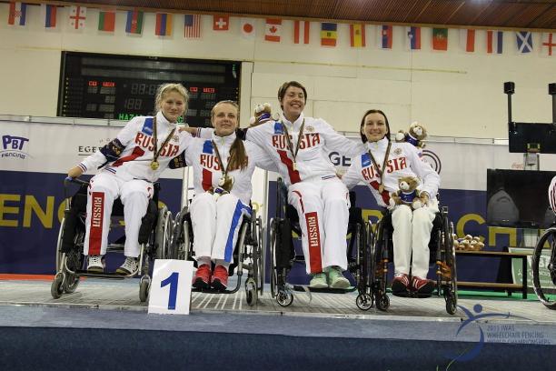 Viktoria Boykova, Yuliya Efimova and Alena Evdokimova - Russia - Wheelchair fencing Four women in wheelchairs on a podium, posing with medals