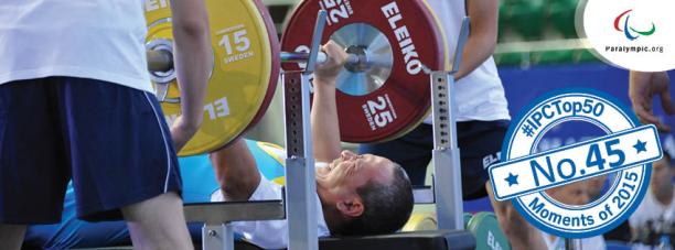 Powerlifter on a bench, raising a bar