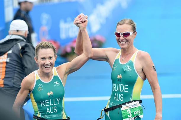 Katie Kelly - Australia - triathlon Two women in jerseys smiling and raising her arms