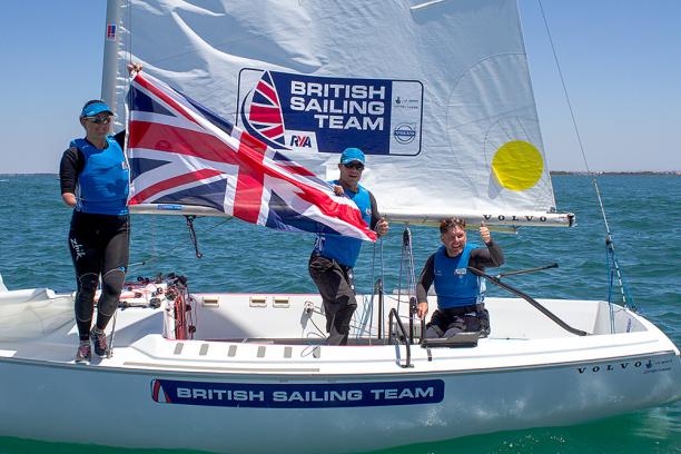 Three people on a boath showing the British flag