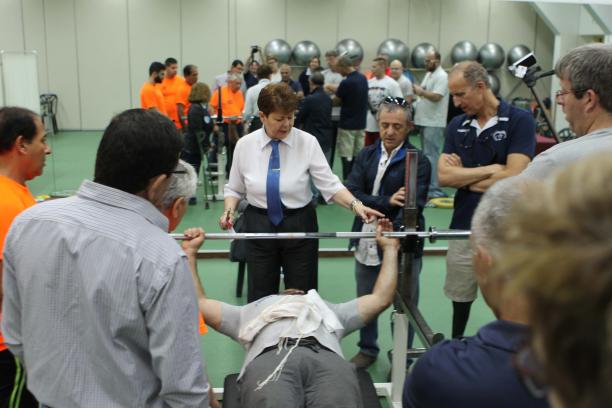 Israel para-powerlifting development programme Group of people discussing and standing around a bench