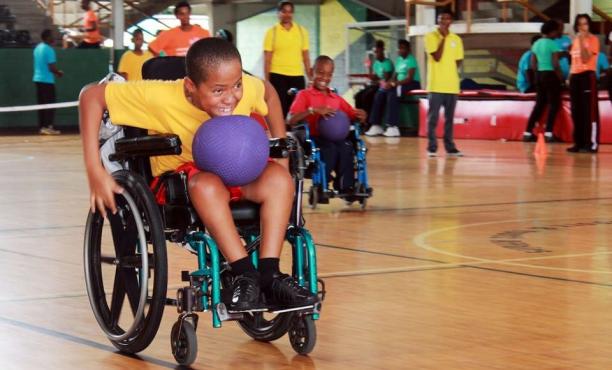 Young boy playing wheelchair rugby