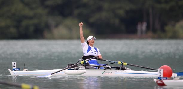 Woman in roing boat celebrates