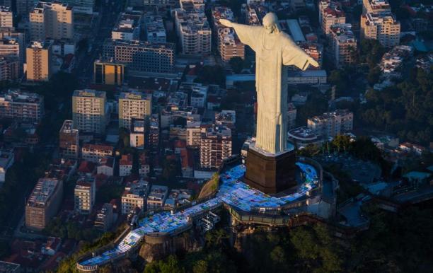 The giant flag was divided into seven pieces to be transported up to the Christ statue 