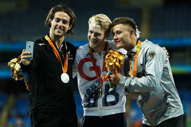 Liam Malone, Jonnie Peacock and Felix Streng take a selfie on the podium