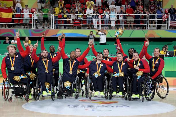 USA - men's wheelchair basketball Group of men in wheelchairs celebrate after winning gold.