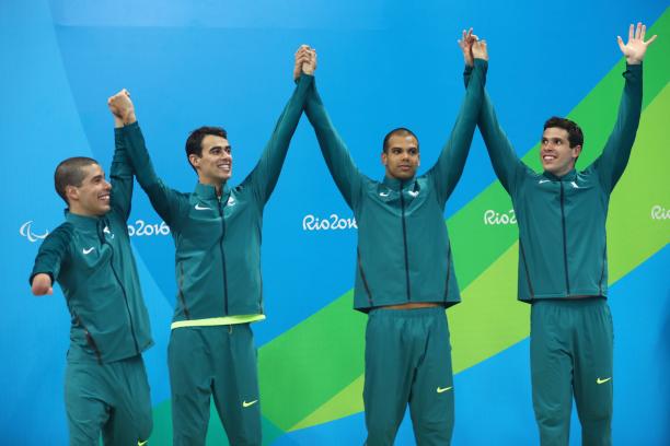 Brazilian swimming relay team Four Brazilian swimmers on a podium celebrating