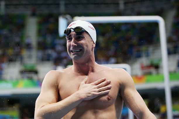 A swimmer is delighted with his victory.