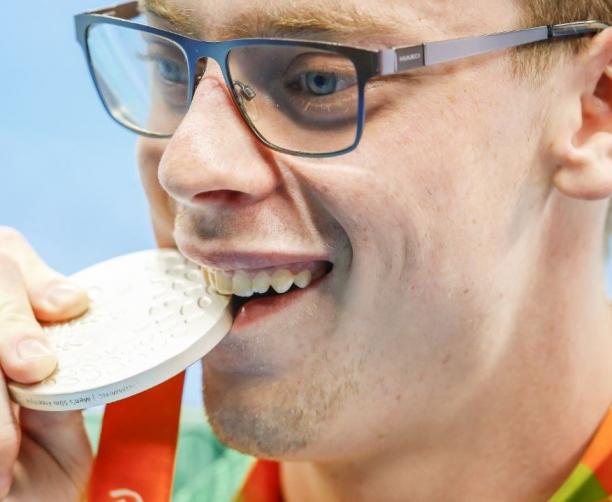 Face of a man biting on a medal