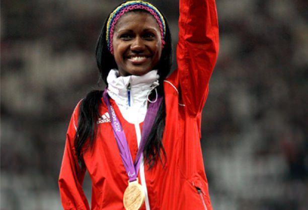 A picture of a woman showing her gold medal