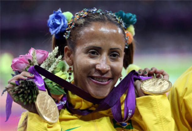 A picture of a woman showing her both gold medals