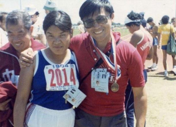 Yali Ping - China - Stoke Mandeville 1984 Two people posing for a photo in track clothes