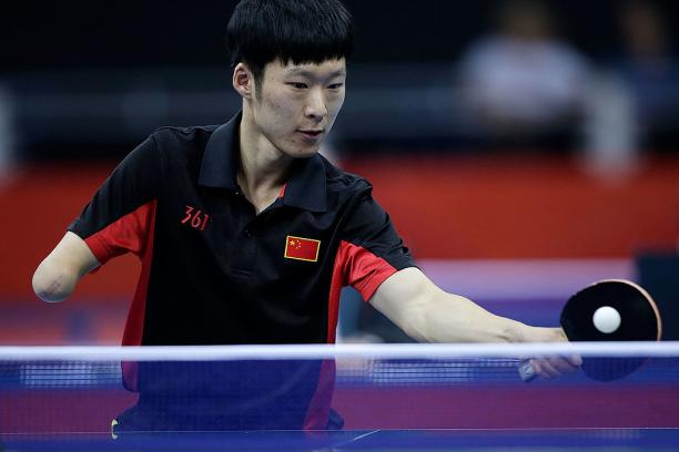 Yang Ge Yang Ge of China returns serve against Sebastian Powrozniak of Poland during the final of the Men's Team Table Tennis - Class 9-10 London 2012