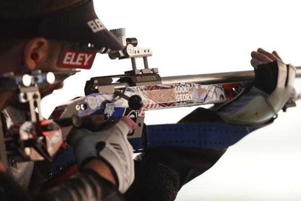 A shooting para athlete holding a rifle.
