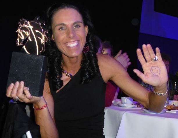 Michèle George A picture of a woman showing her trophy