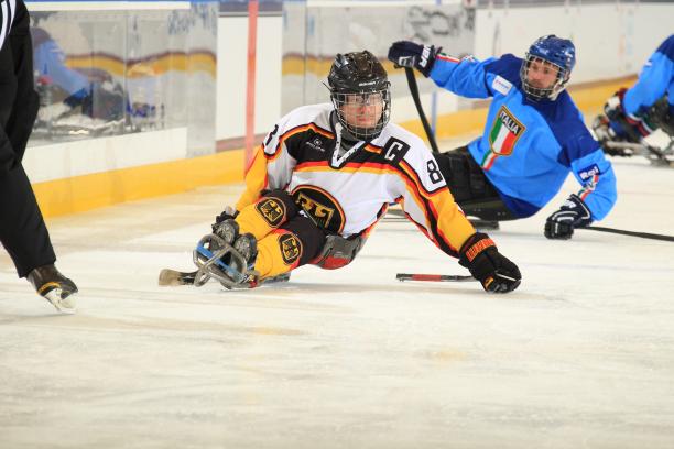 Man on ice sledge hockey makes a turn